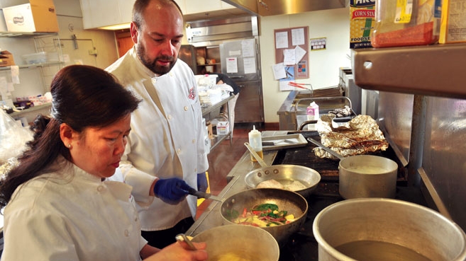 Director of campus dining Richard Phillips and head catering chef Hang Lovan prepare a meal at Central College